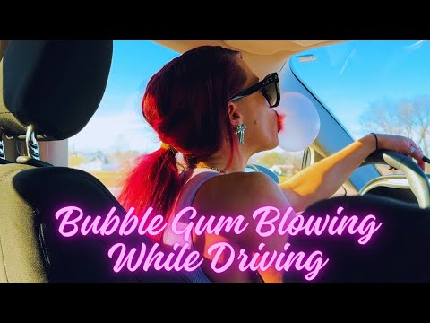 Backseat View of Bubble Gum Blowing while Driving