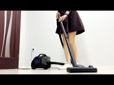 A girl in a dress cleans the house with a bagless vacuum cleaner. Bosch BGS21X320. Clean with me