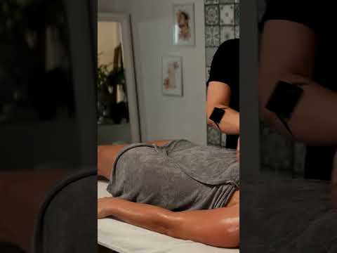 Mila and Olivia focus on back massage techniques, using warm oil and gentle strokes to melt tension