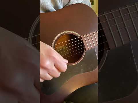 strummin' an acoustic Guild guitar