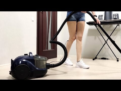 Bosch BGS21X320. A girl in shorts and a t-shirt cleans the house with a bagless vacuum cleaner. 2