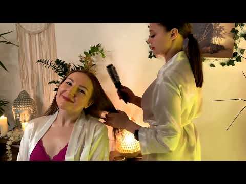 Mira and Veronica work on hair with gentle strokes, using warm oil to ease tension in a serene atmos