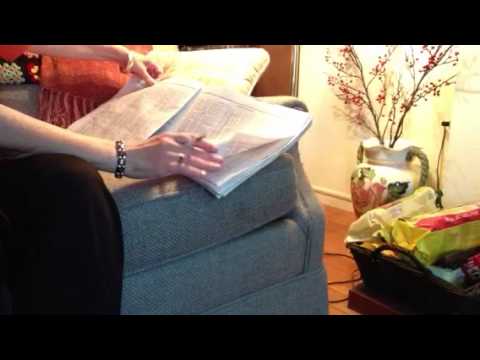 ASMR newspaper page turning, no talking; some inaudible whisper