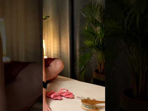 Dominique's hands trace the curve of the Client's leg, applying gentle pressure that melts tension a