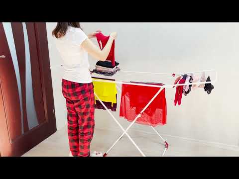 Sorting clean laundry after drying. Folding clothes and linen after drying. Homemaking