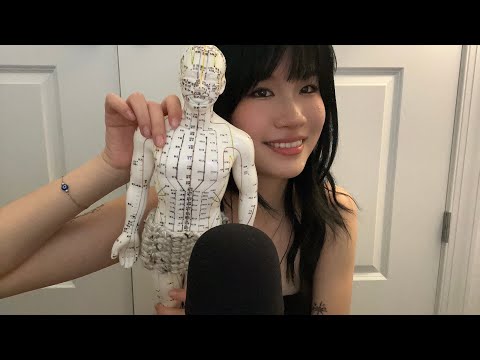 ASMR tapping and massaging the acupuncture doll
