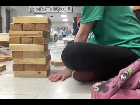 Playing Jenga with my friend.