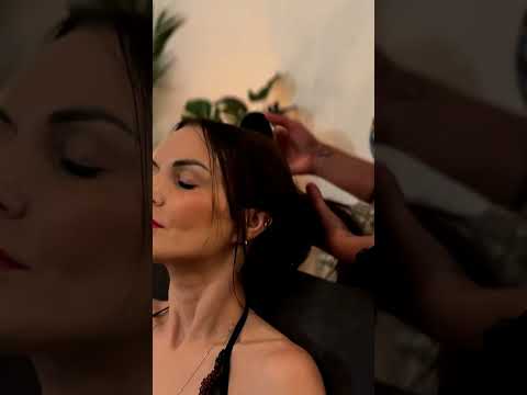 Veronica's hands trace warm oil across the Client's neck, unraveling tension with delicate strokes a