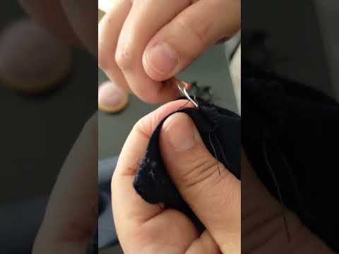 unstitching the hem of a trouser in an asmr way