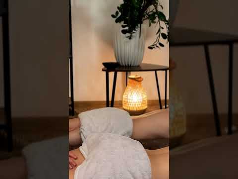 Veronica's hands glide over the Client's back, tracing gentle circular motions as warm light bathes
