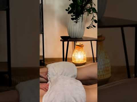 Veronica's hands glide over the Client's back, tracing gentle circular motions as warm light bathes