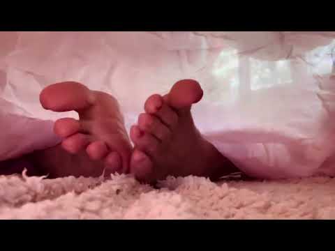 ASMR bare feet playing gently under silk