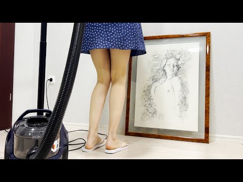 A girl in a dress vacuums carpets, wipes a picture. Clean with me