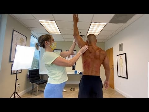 Watch Little Female Chiropractor Make Strong Man Wince In Pain
