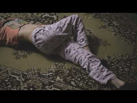 What to do if your back hurts? Lying on my back, I do the exercise. Girl in pajamas