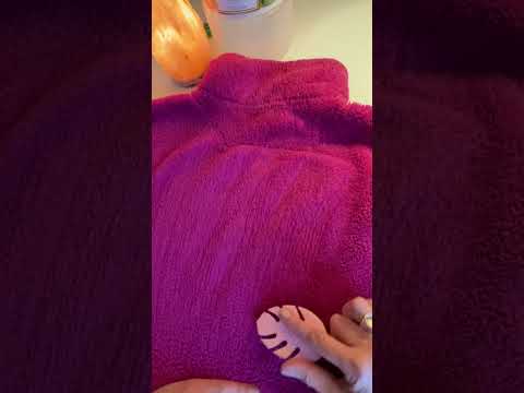 Brushing a fluffy pink sherpa sweater.