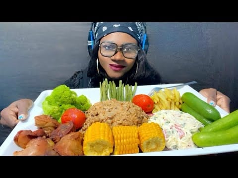 EATING JOLLOF RICE, CREAMY SALAD, FRIED CHKEN, GREEN BEANS, BROCCOLI, SWEET CORN,FFRIES, & PICKLES