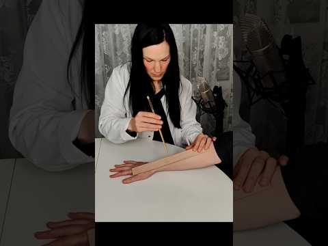 Checking his arm and fingers