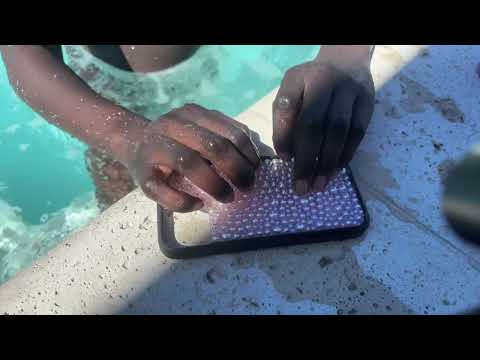 Textured phone case tapping in hot tub